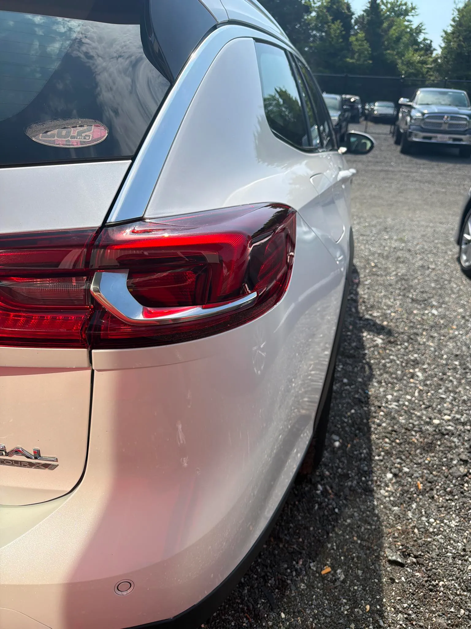 White Buick after repair, rear bumper corner restored