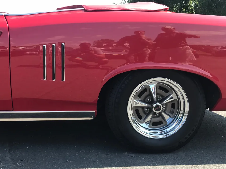 Show-quality red paint and chrome on a restored Pontiac Firebird
